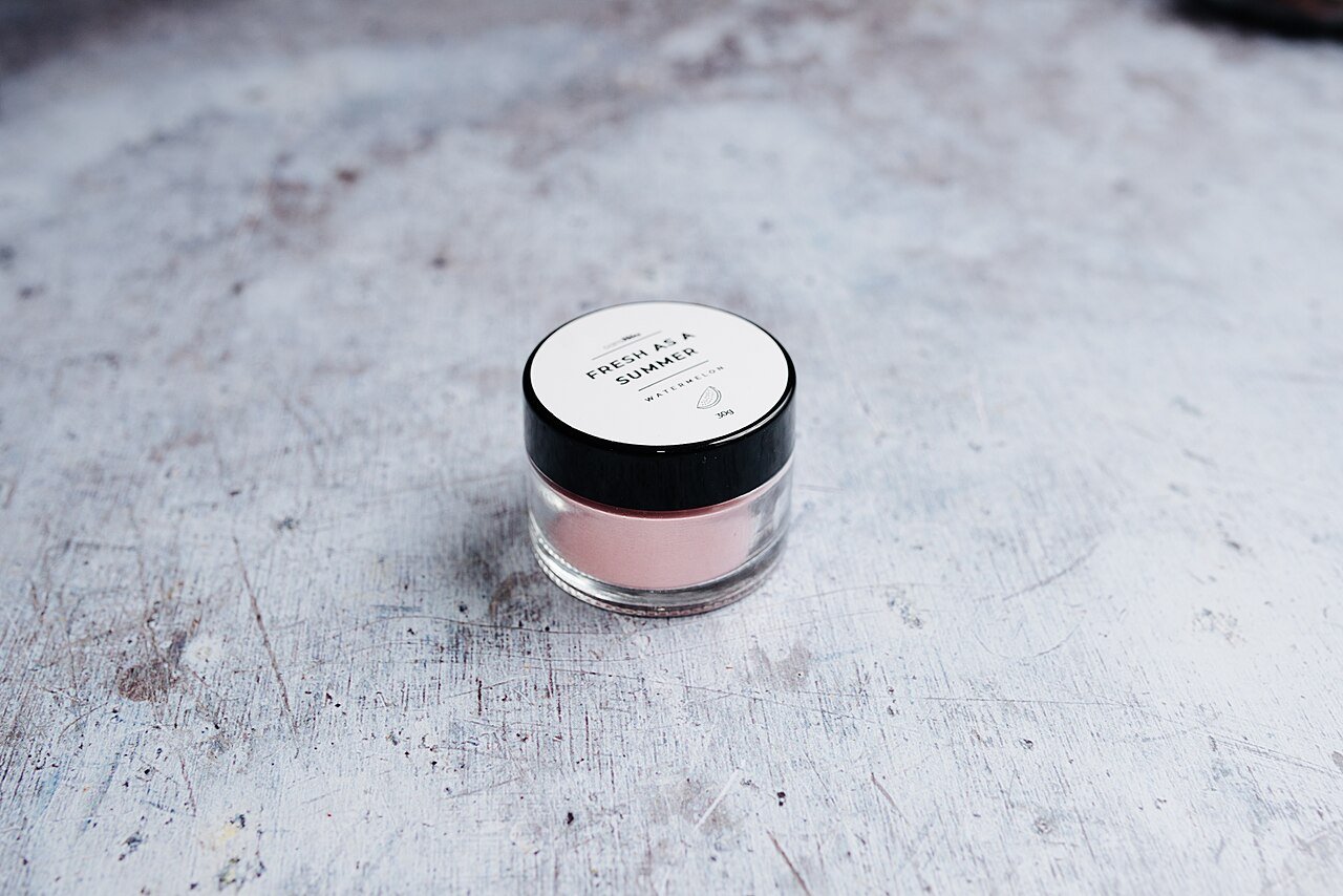 A jar of rich pink night cream for overnight masks